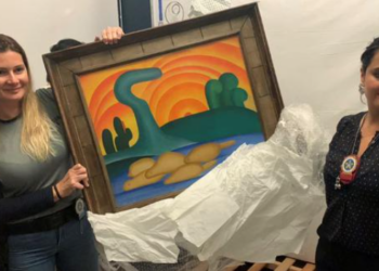Policías sostienen la pintura 'Sol Poente' de la artista brasileña Tarsila do Amaral. Foto: AFP.