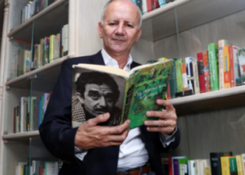 El coleccionista colombiano Jorge Salazar sostiene una edición en inglés de la obra 'Cien años de soledad', de Gabriel García Márquez. Foto: AFP.
