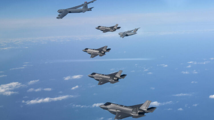 Cuatro cazas surcoreanos F-35 vuelan sobre su país junto a un bombardero B-52 (arriba izq) y un avión de carga C-17 (dcha) de EEUU durante unas maniobras conjuntas, imagen tomada y divulgada por el Ministerio de Defensa surcoreano el 20 de diciembre de 2022. Foto: AFP.