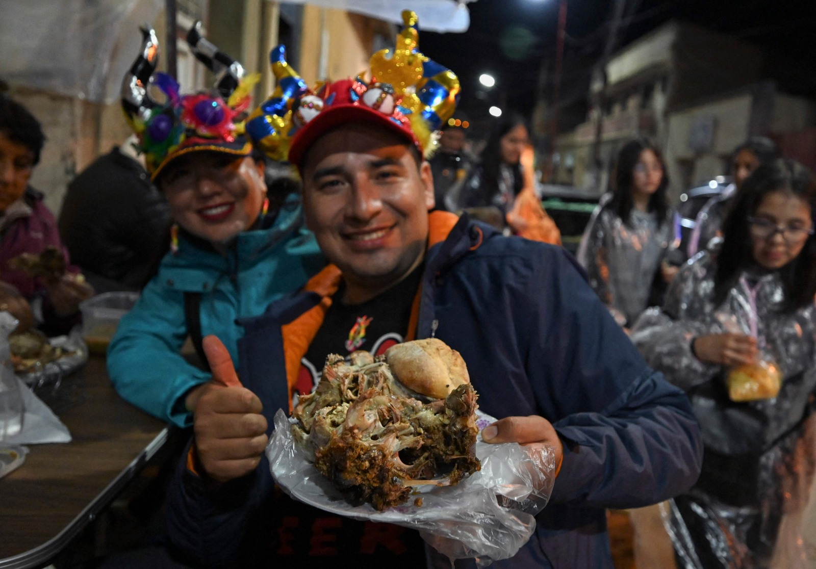 Un comensal degusta el rostro asado orureño, famoso plato de cabeza de cordero. Foto: AFP