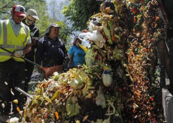 Funcionarios municipales de recogen desechos orgánicos en el barrio La Pintana de Santiago de Chile. Foto: AFP.